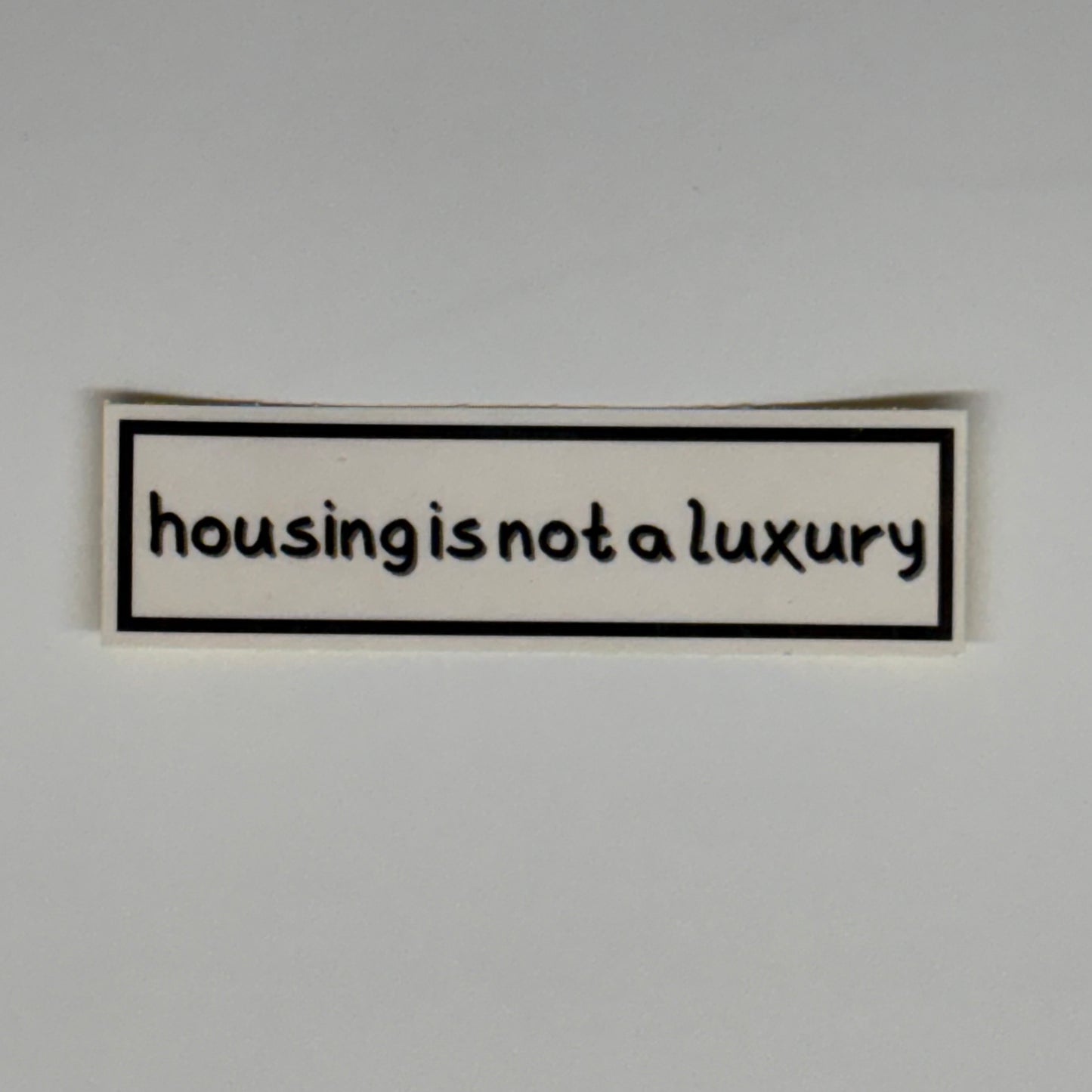 housing is not a luxury sticker