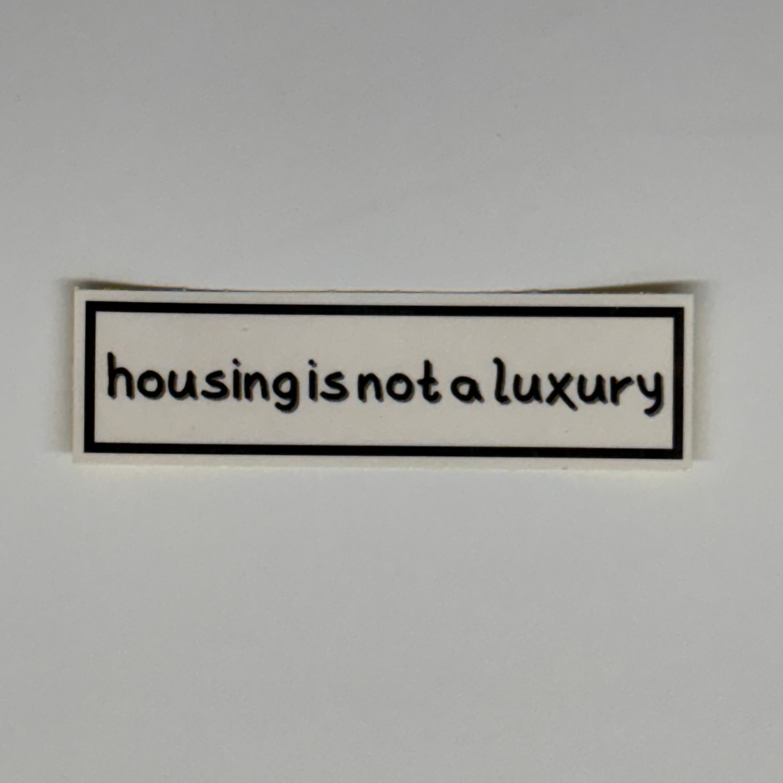 housing is not a luxury sticker