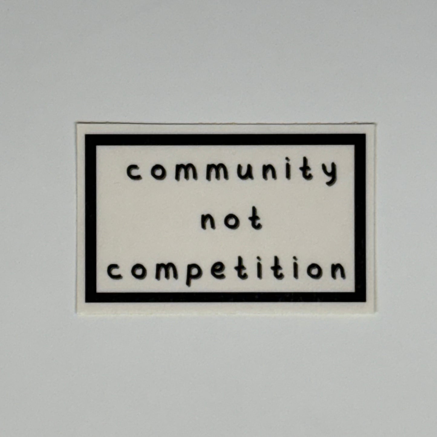 community not competition sticker
