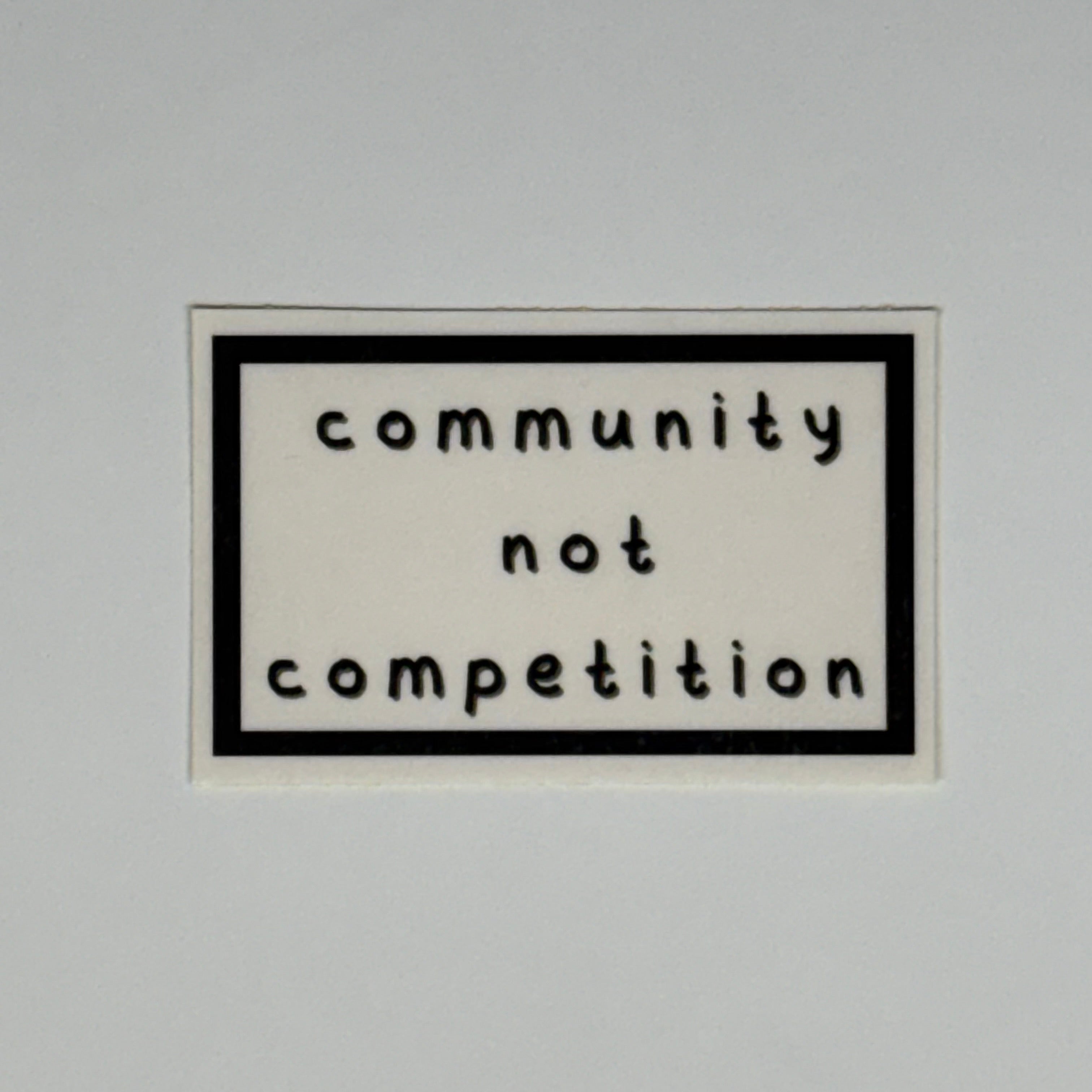 community not competition sticker